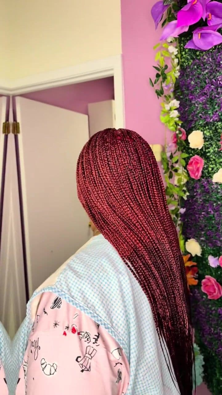 Side view of fine wine red micro braids past the waist