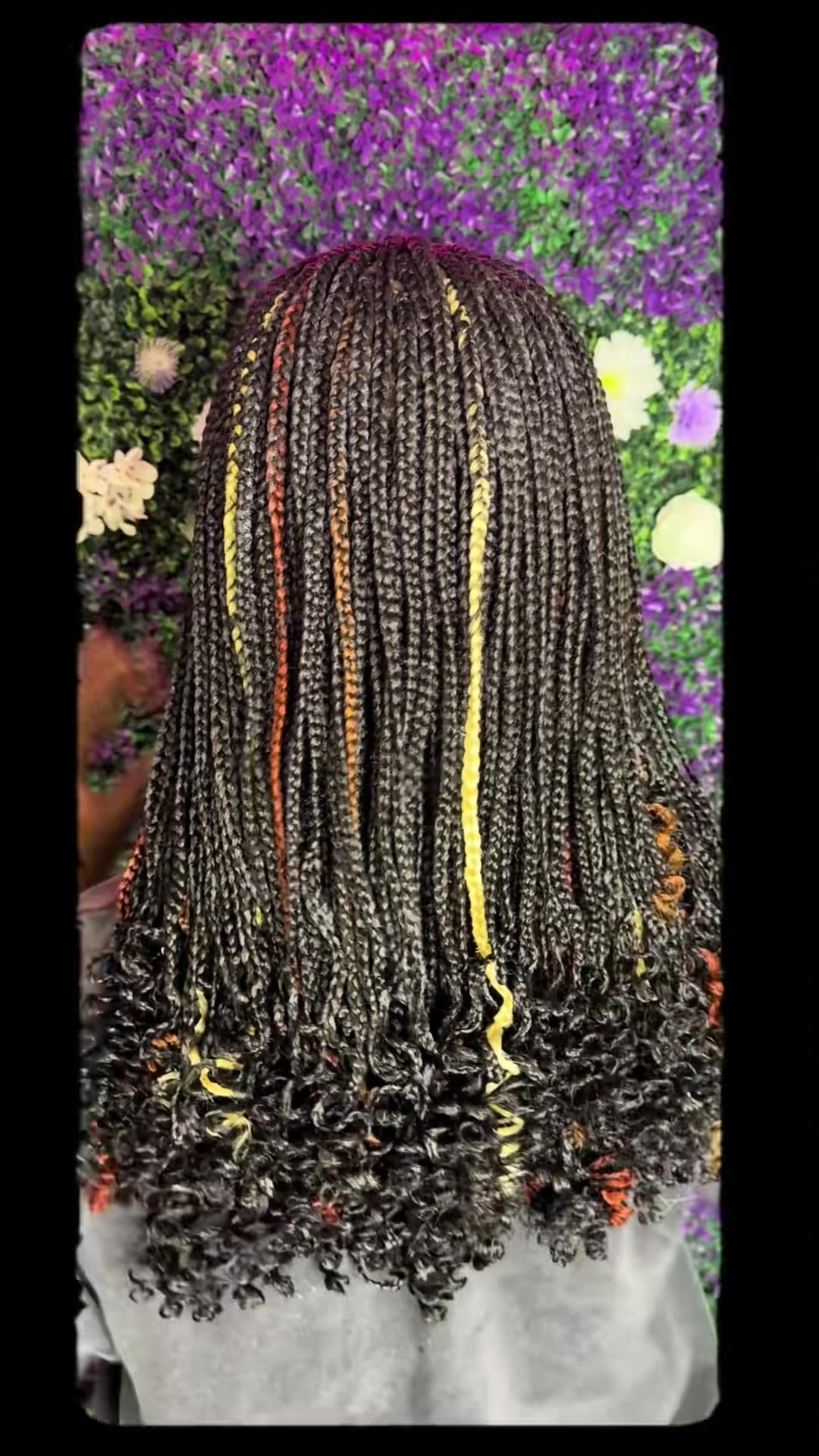 Back view of braids with yellow accent strands and curled ends